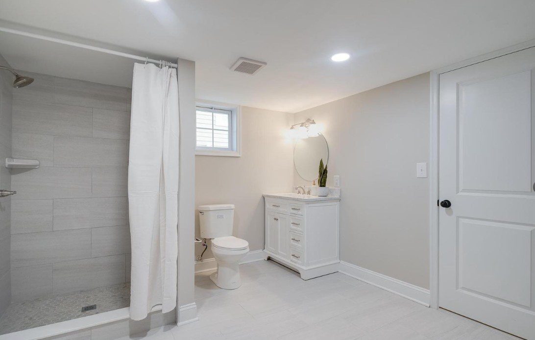 Bright white bathroom with shower and vanity