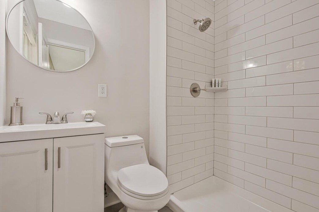 Modern white bathroom with subway tile shower