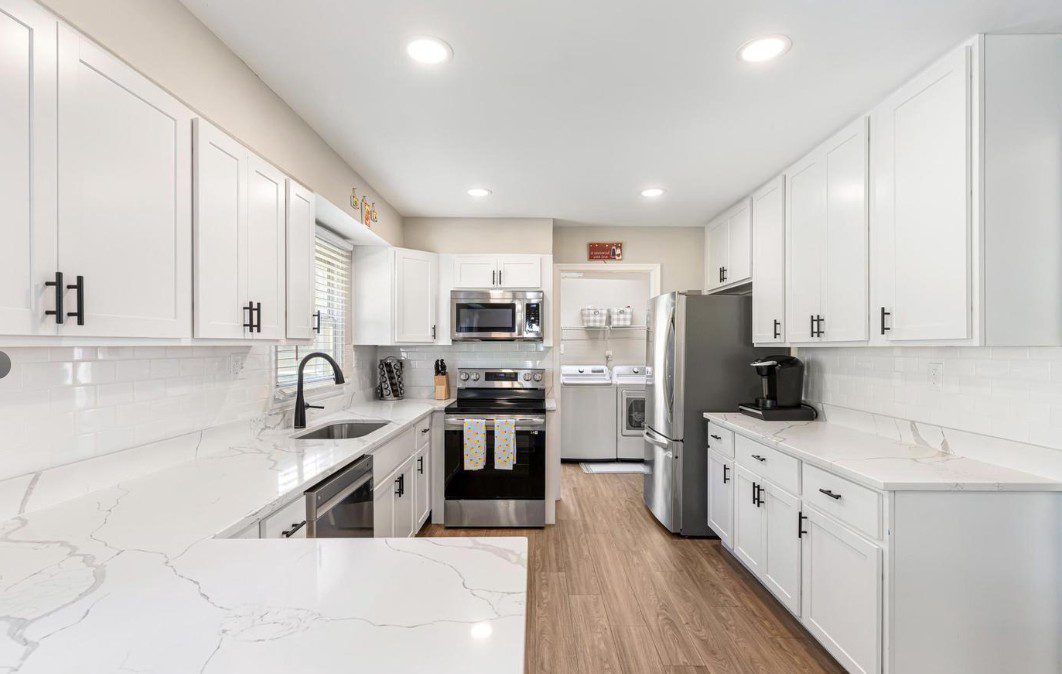 Bright modern white kitchen with stainless appliances
